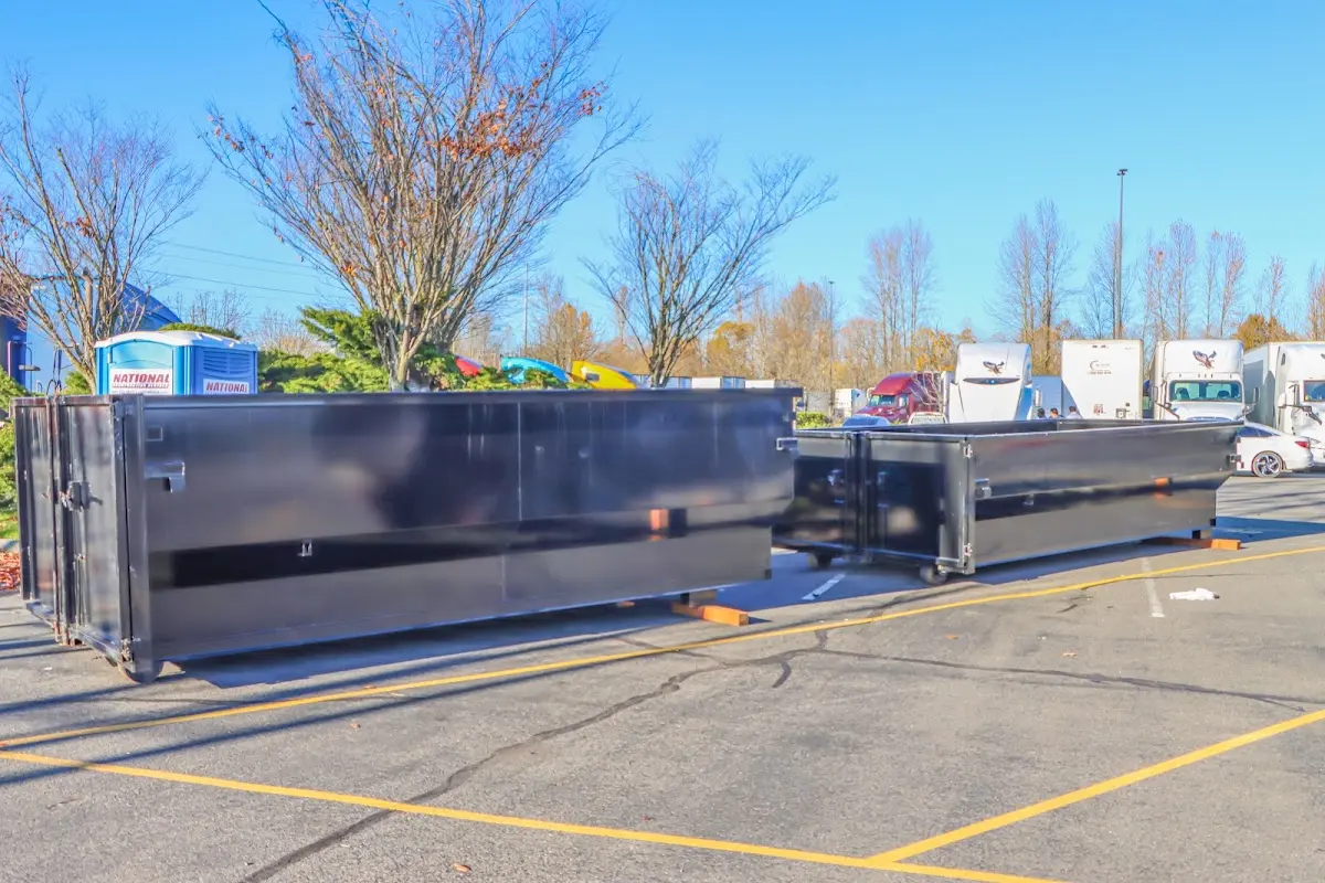 Professional dumpster rental service with roll-off container on residential driveway in Pleasure Point